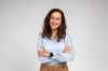 Smiling friendly confident millennial caucasian lady manager, teacher in formal wear with crossed arms on chest, isolated on gray background studio background. Work, study, courses and business